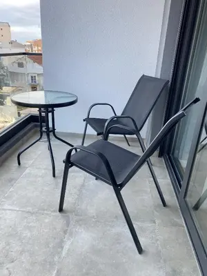 two chairs and a table on a balcony at AZZURRO BAR Apartment in Bar