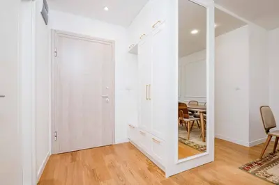 a hallway with a mirror and a dining room at Sunny View in Bar