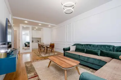 a living room with a green couch and a table at Sunny View in Bar