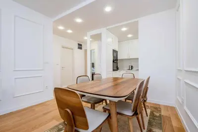 a kitchen and dining room with a wooden table and chairs at Sunny View in Bar