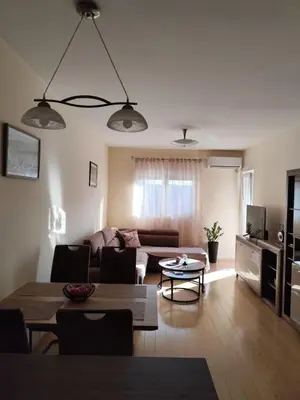 a living room with a couch and a table at Apartman City kvart Podgorica 2 in Podgorica