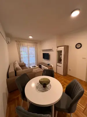 a living room with a table and a couch at Apartman Luka in Cetinje