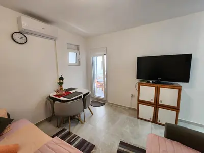 a living room with a flat screen tv on the wall at Inga - Apartment Ulcinj sea view in Ulcinj