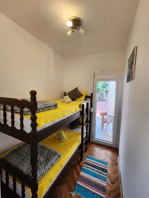 a bedroom with two bunk beds and a sliding glass door at Inga - Apartment Ulcinj sea view in Ulcinj