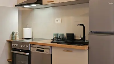 a kitchen with a stove and a sink in it at 'July' Studio in Podgorica