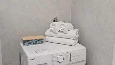 a stack of towels on top of a washing machine at 'July' Studio in Podgorica