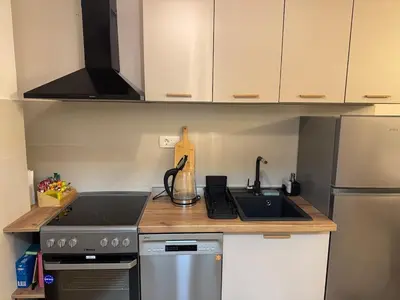 a small kitchen with a stove and a sink at 'July' Studio in Podgorica