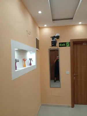 a person taking a picture in a mirror in a room at Grandino rooms& apartments in Ulcinj
