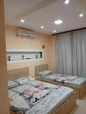 a bedroom with two beds and a window at Grandino holidays rooms&appart in Ulcinj