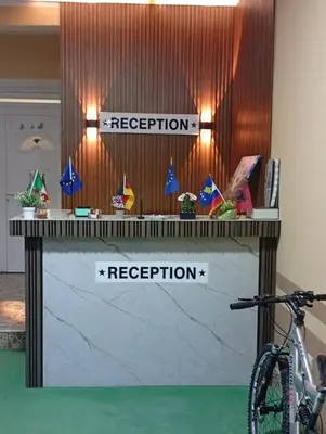 a reception desk with two signs for inspection and a bike at Grandino holidays rooms&appart in Ulcinj