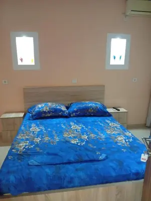 a bedroom with a blue bed with two pillows at Grandino holidays rooms&appart in Ulcinj