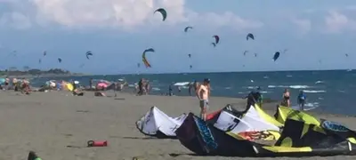 a group of people on the beach flying kites at Grandino holidays rooms&appart in Ulcinj