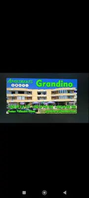a sign for a building on top of a television at Grandino holidays rooms&appart in Ulcinj