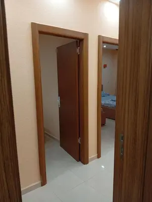 a hallway with two open doors in a room at Grandino holidays rooms&appart in Ulcinj