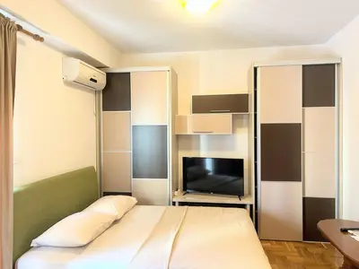 a bedroom with a bed and a tv in it at Urban studio Blok 9 in Podgorica