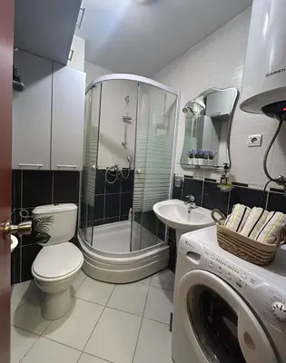 a bathroom with a shower and a toilet and a sink at Urban studio Blok 9 in Podgorica