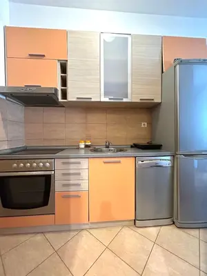 a kitchen with stainless steel appliances and cabinets at Urban studio Blok 9 in Podgorica