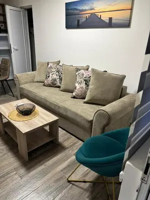 a living room with a couch and a table at Vila Seawolf Apartments in Sutomore