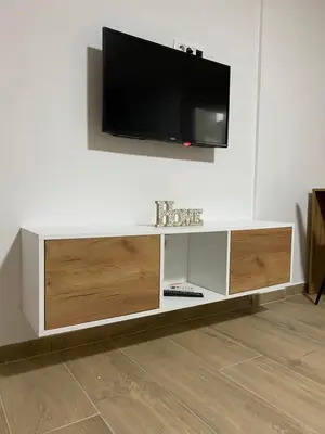 a living room with a tv on a wall at Vila Seawolf Apartments in Sutomore