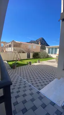 a view of a patio with a house and mountains at Vila Seawolf Apartments in Sutomore