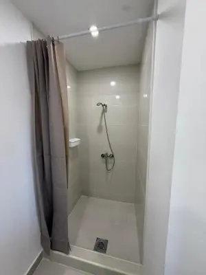 a bathroom with a shower with a shower curtain at La Belle Saison