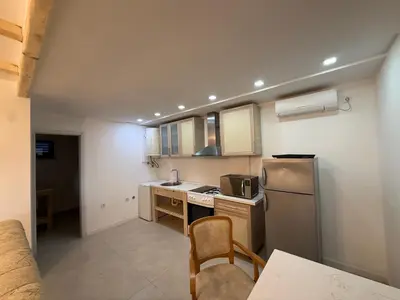 a small kitchen with a sink and a refrigerator at La Belle Saison