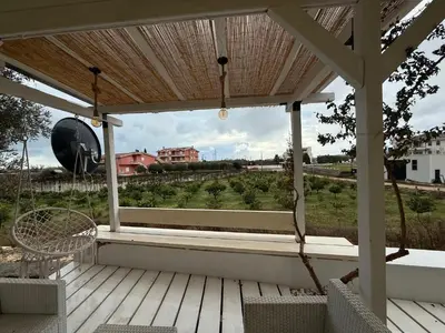 a porch with chairs and a view of a field at La Belle Saison