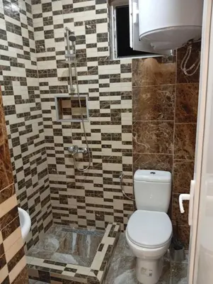 a bathroom with a toilet and a shower at Grandino Space room&apart Ulqin in Ulcinj