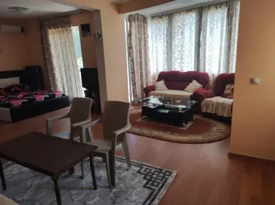 a living room with a couch and a table and chairs at Grandino Space room&apart Ulqin in Ulcinj