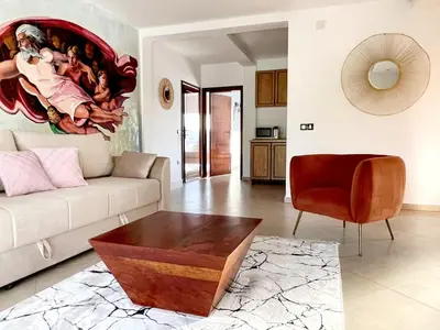 a living room with a couch and a table at Le Domaine paradise