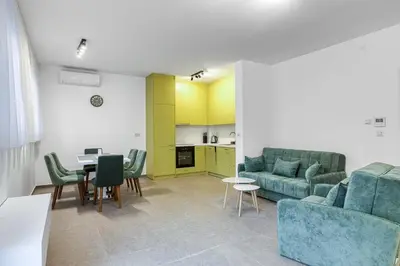 a living room with a couch and a table at Green Oasis Bečići in Boreti
