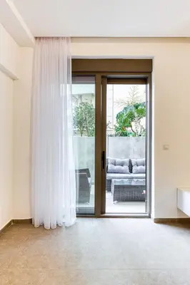 a living room with a sliding glass door at Green Oasis Bečići in Boreti
