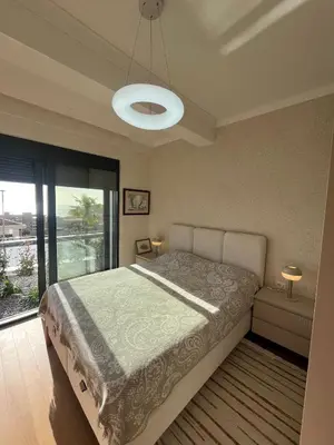 a bedroom with a bed and a large window at OLIVA RESIDENCe in Petrovac na Moru
