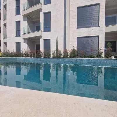 a swimming pool in front of a building at OLIVA RESIDENCe in Petrovac na Moru