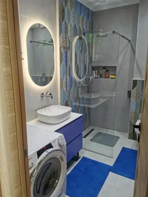 a bathroom with a washing machine and a washer at OLIVA RESIDENCe in Petrovac na Moru