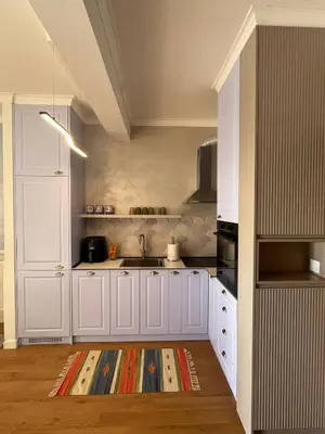 a kitchen with white cabinets and a sink at OLIVA RESIDENCe in Petrovac na Moru