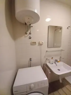 a bathroom with a toilet and a sink at City kvart apartman in Podgorica