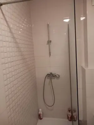 a bathroom with a shower with a glass door at City kvart apartman in Podgorica