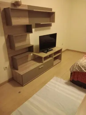 a living room with a flat screen tv on a entertainment center at City kvart apartman in Podgorica