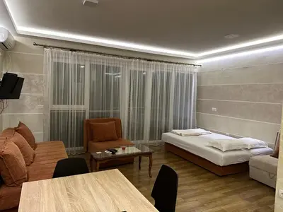 a room with a bed and a couch and a table at Oaza mira Sutomore in Bar