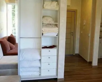 a room with a white closet with folded towels at Oaza mira Sutomore in Bar