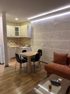 a living room with a table and a couch at Oaza mira Sutomore in Bar