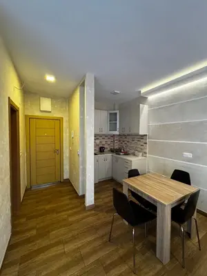 a kitchen and dining room with a table and chairs at Oaza mira Sutomore in Bar