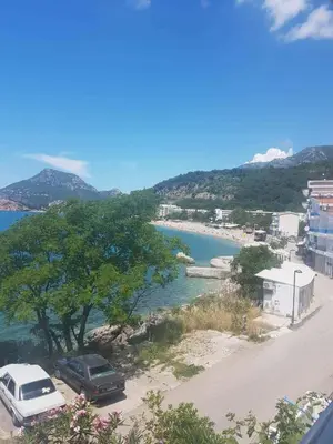 a beach with two cars parked next to a river at Apartmani Micunovic in Sutomore