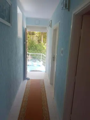 a hallway with a door leading to a patio at Apartmani Micunovic in Sutomore