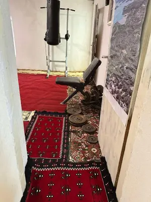 a hallway with a chair and a rug on the floor at Etno Village Revival