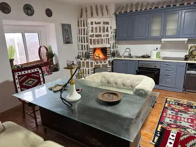 a living room with a coffee table and a kitchen at Etno Village Revival