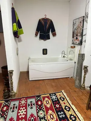 a bathroom with a bath tub and a coat hanging on the wall at Etno Village Revival