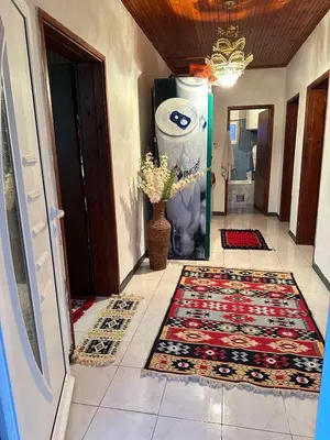 a hallway with a rug on a tiled floor and a door at Etno Village Revival