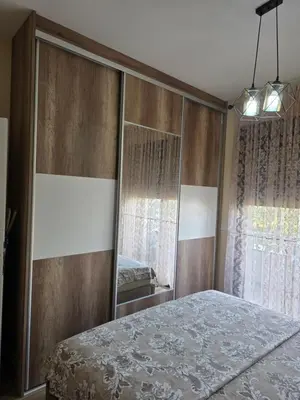 a bedroom with a mirror and a bed at S&M Stan in Ulcinj